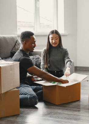 Two students packing boxes together