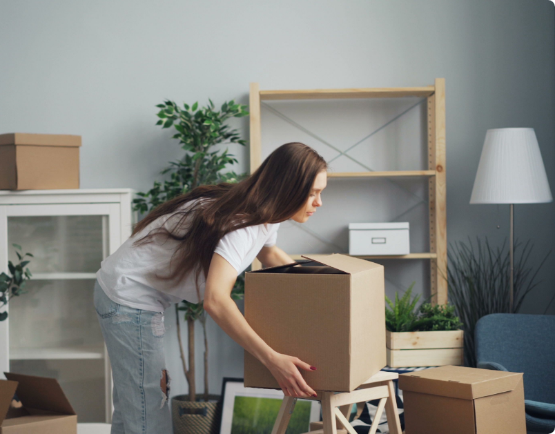Student moving a packed storage box